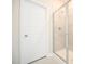 Bathroom featuring a glass-enclosed shower with tiled walls and a white paneled door at 138 Abingdon Farms Dr, Selma, NC 27576