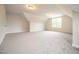 Carpeted room with angled ceilings, illuminated by a window at 138 Abingdon Farms Dr, Selma, NC 27576