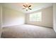Bedroom featuring neutral carpet, ceiling fan, and a large window at 138 Abingdon Farms Dr, Selma, NC 27576