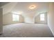 Spacious carpeted bedroom with angled ceilings and multiple windows at 138 Abingdon Farms Dr, Selma, NC 27576