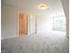 Spacious carpeted bedroom with a bathroom and closet, illuminated by a window at 138 Abingdon Farms Dr, Selma, NC 27576