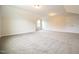 Spacious bonus room with neutral carpeting, recessed lighting, and a door at 138 Abingdon Farms Dr, Selma, NC 27576