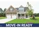 Move-in ready two-story house with stone and siding, two-car garage, and landscaped lawn at 138 Abingdon Farms Dr, Selma, NC 27576