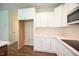 Close-up of white kitchen cabinets, countertops, and stainless steel appliances at 138 Abingdon Farms Dr, Selma, NC 27576