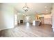 Spacious open-concept floorplan with hardwood floors, fireplace, and view of stairs to upper level at 138 Abingdon Farms Dr, Selma, NC 27576