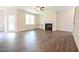 Spacious living room with wood floors, a fireplace, and plenty of natural light at 138 Abingdon Farms Dr, Selma, NC 27576