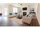 Bright living room with wood floors, a fireplace, built-in shelves, and comfortable seating at 138 Abingdon Farms Dr, Selma, NC 27576