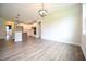 Open floor plan featuring hardwood floors and views into the kitchen with white cabinets at 138 Abingdon Farms Dr, Selma, NC 27576