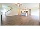 Open-concept living room and kitchen area with hardwood floors and staircase at 138 Abingdon Farms Dr, Selma, NC 27576