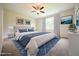 Staged main bedroom with tufted headboard, side tables, and ceiling fan at 138 Abingdon Farms Dr, Selma, NC 27576