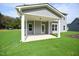 Covered back porch with gray siding and a view of the spacious backyard at 236 Abingdon Farms Dr, Selma, NC 27576