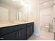 Bright bathroom featuring a double sink vanity with white countertops and a private toilet area at 236 Abingdon Farms Dr, Selma, NC 27576