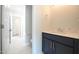Bathroom with blue vanity, stone countertop and tile floor with easy access to other rooms at 236 Abingdon Farms Dr, Selma, NC 27576