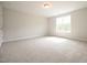 Spacious bedroom with neutral walls, carpet, and a large window for natural light at 236 Abingdon Farms Dr, Selma, NC 27576