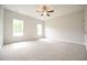 Empty bedroom with two windows, carpet, and a ceiling fan at 236 Abingdon Farms Dr, Selma, NC 27576