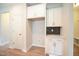 Bright kitchen featuring white cabinets, stainless hardware, and black backsplash at 236 Abingdon Farms Dr, Selma, NC 27576