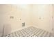 Laundry room with patterned floors, wire shelving, and utility connections at 236 Abingdon Farms Dr, Selma, NC 27576