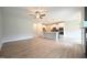 Spacious living room with hardwood floors that transition into the kitchen with modern appliances at 236 Abingdon Farms Dr, Selma, NC 27576