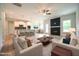Open-concept living room featuring fireplace, ceiling fan, and seamless flow to the kitchen and dining area at 236 Abingdon Farms Dr, Selma, NC 27576