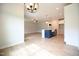 Open-concept living space with wood floors, ample lighting, and a view into the kitchen at 236 Abingdon Farms Dr, Selma, NC 27576