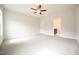 Spacious main bedroom featuring neutral tones, carpet, ceiling fan, and ensuite bathroom access at 236 Abingdon Farms Dr, Selma, NC 27576