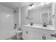 Bright bathroom with double sink vanity, white cabinets and counters, and framed mirrors above at 733 Portland Rose Dr, Knightdale, NC 27545