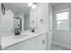 Bathroom featuring double sink vanity with white counters and modern fixtures with a framed mirror at 733 Portland Rose Dr, Knightdale, NC 27545