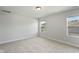 Bright bedroom with neutral carpet, fresh paint, and natural light from two windows at 733 Portland Rose Dr, Knightdale, NC 27545
