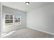 Neutral bedroom with carpet, trim, and a double window bringing in natural light at 733 Portland Rose Dr, Knightdale, NC 27545