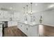 Modern kitchen featuring a large island with granite countertop and white cabinets at 733 Portland Rose Dr, Knightdale, NC 27545