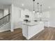 Modern kitchen featuring a large island with granite countertop and white cabinets at 733 Portland Rose Dr, Knightdale, NC 27545