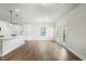Bright, open-concept living room with wood floors, white walls, and a kitchen island at 733 Portland Rose Dr, Knightdale, NC 27545