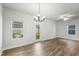 Bright, open-concept living room with wood floors, white walls, and updated lighting at 733 Portland Rose Dr, Knightdale, NC 27545