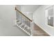 Elegant staircase featuring hardwood steps, white risers, and wrought iron balusters at 733 Portland Rose Dr, Knightdale, NC 27545