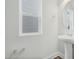 Bright bathroom featuring a pedestal sink, a window, and chrome towel bars at 737 Portland Rose Dr, Knightdale, NC 27545