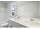 Bathroom featuring a double sink vanity with a large mirror and a window at 737 Portland Rose Dr, Knightdale, NC 27545