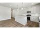 Modern kitchen with stainless steel appliances, white cabinets and island at 737 Portland Rose Dr, Knightdale, NC 27545