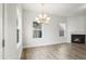 Bright living room featuring a fireplace, chandelier and large windows at 737 Portland Rose Dr, Knightdale, NC 27545