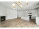 Spacious living room with fireplace that connects to the kitchen with modern countertops and stainless appliances at 737 Portland Rose Dr, Knightdale, NC 27545