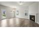 Bright living room with fireplace, ceiling fan, and access to the outdoors at 737 Portland Rose Dr, Knightdale, NC 27545