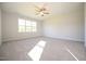 This bedroom has neutral walls, soft carpet, and a ceiling fan with a light at 76 Abingdon Farms Dr, Selma, NC 27576