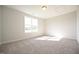 This bedroom features neutral walls, soft carpet, and a large window at 76 Abingdon Farms Dr, Selma, NC 27576