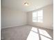 Bright bedroom features neutral walls, carpet, and a window allowing for natural light at 76 Abingdon Farms Dr, Selma, NC 27576