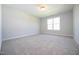 Bright bedroom features neutral walls, carpet, and a window allowing for natural light at 76 Abingdon Farms Dr, Selma, NC 27576