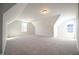 Large bonus room with carpet and natural light from two windows at 76 Abingdon Farms Dr, Selma, NC 27576