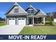 Move-in ready two-story home with gray siding, two-car garage, and landscaped lawn at 76 Abingdon Farms Dr, Selma, NC 27576