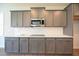 Stylish kitchen with grey cabinetry, quartz countertops, subway tile backsplash, and stainless steel appliances at 76 Abingdon Farms Dr, Selma, NC 27576