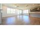 Spacious living area with large windows and abundant light transitions to kitchen with island seating at 76 Abingdon Farms Dr, Selma, NC 27576