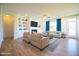 Bright and airy living room boasts hardwood floors, fireplace, built-in bookshelves, and plenty of natural light at 76 Abingdon Farms Dr, Selma, NC 27576