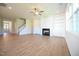 Open-concept living room with hardwood floors, fireplace, and built-in shelves, ideal for modern living at 76 Abingdon Farms Dr, Selma, NC 27576